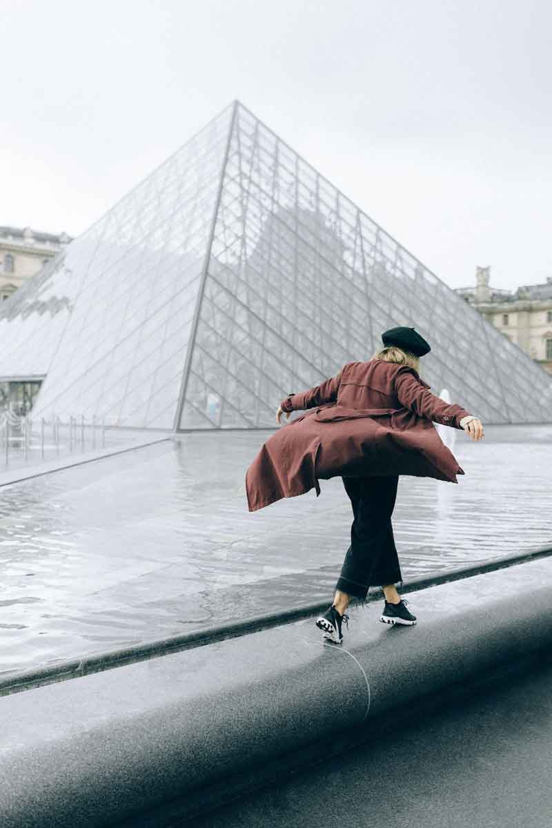 femme qui marche le long du louvre